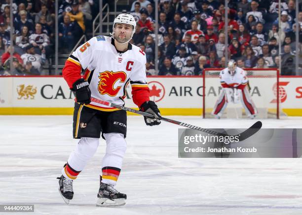 Mark Giordano of the Calgary Flames keeps an eye on the play during first period action against the Winnipeg Jets at the Bell MTS Place on April 5,...