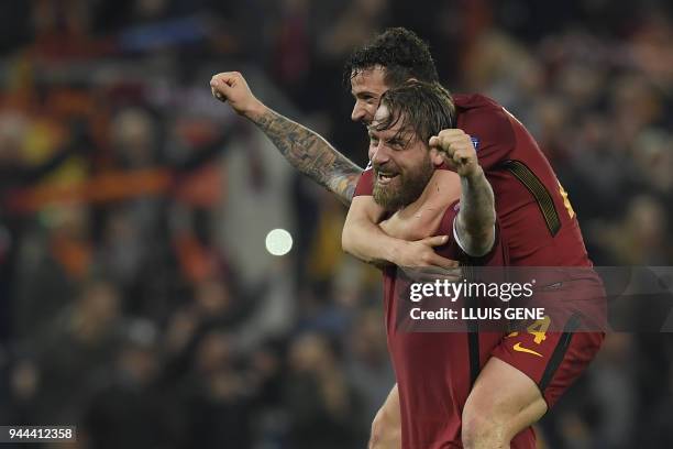 Roma's Italian midfielder Daniele De Rossi and AS Roma's Italian midfielder Alessandro Florenzi celebrate after winning the UEFA Champions League...