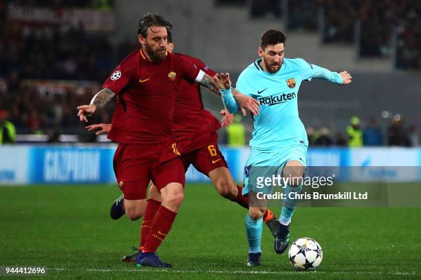Daniele De Rossi of AS Roma in action with Lionel Messi of FC Barcelona during the UEFA Champions League Quarter Final, second leg match between AS...