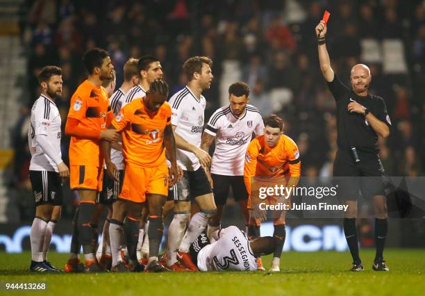 Leandro Bacuna of Reading is shown a red card by referee Lee Mason during the Sky Bet Championship match between Fulham and Reading at Craven Cottage...
