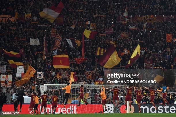 Roma's players celebrate their victory at the end of the UEFA Champions League quarter-final second leg football match between AS Roma and FC...