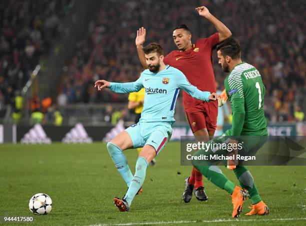 Gerard Pique of Barcelona holds off Bruno Peres of AS Roma and Alisson Becker of AS Roma UEFA Champions League Quarter Final Second Leg match between...