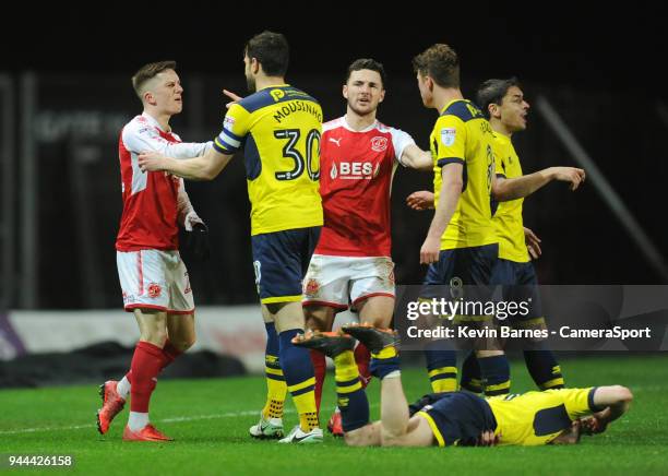 Tempers flare between Fleetwood Town's Ashley Hunter and Oxford United's John Mousinho after a foul on Cameron Brannagan during the Sky Bet League...