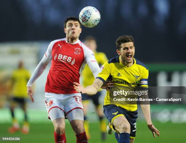 Fleetwood Town's Bobby Grant vies for possession with Oxford United's John Mousinho during the Sky Bet League One match between Oxford United and...