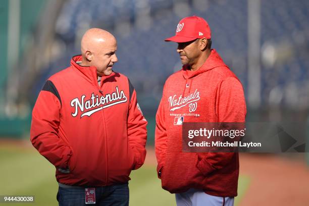 General manager Mike Rizzo and manager Dave Martinez of the Washington Nationals talk during batting practice of a baseball game against the Atlanta...
