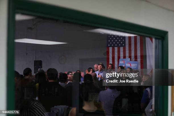 Florida Governor Rick Scott addresses supporters as he holds a Senate campaign rally at the Interstate Beverage Corp. On April 10, 2018 in Hialeah,...