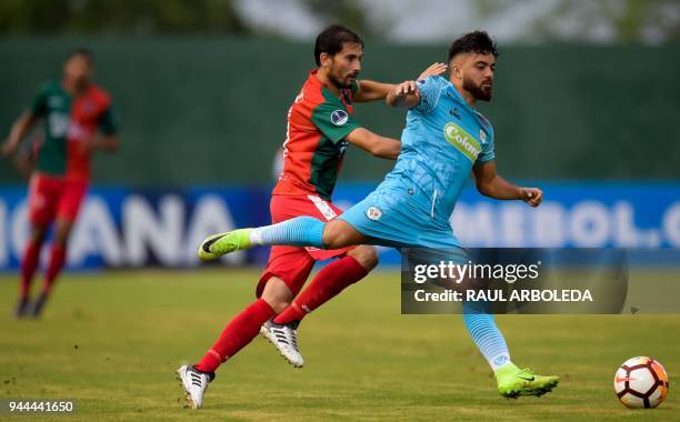 Colombia's Jaguares player Sebastian Villota vies for the ball with Uruguay's Boston River player Robert Flores during their Copa Sudamericana...