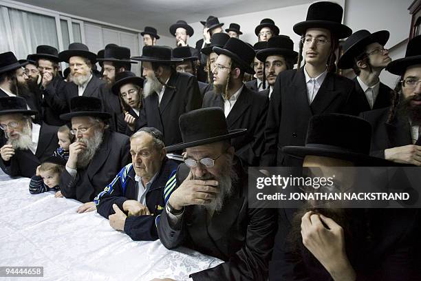 Ultra Orthodox Jewish men attend the candle lighting ceremony for the Jewish festival of Hanukkah in Bnei Brak, near Tel Aviv, on December 14, 2009....