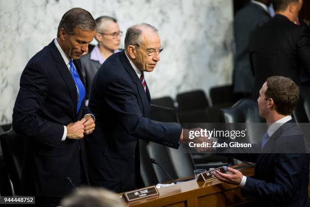Facebook co-founder, Chairman and CEO Mark Zuckerberg shakes hands with U.S. Sen. Chuck Grassley after testifying before a combined Senate Judiciary...