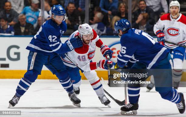 Logan Shaw of the Montreal Canadiens battles for the puck against Tyler Bozak of the Toronto Maple Leafs during the third period at the Air Canada...