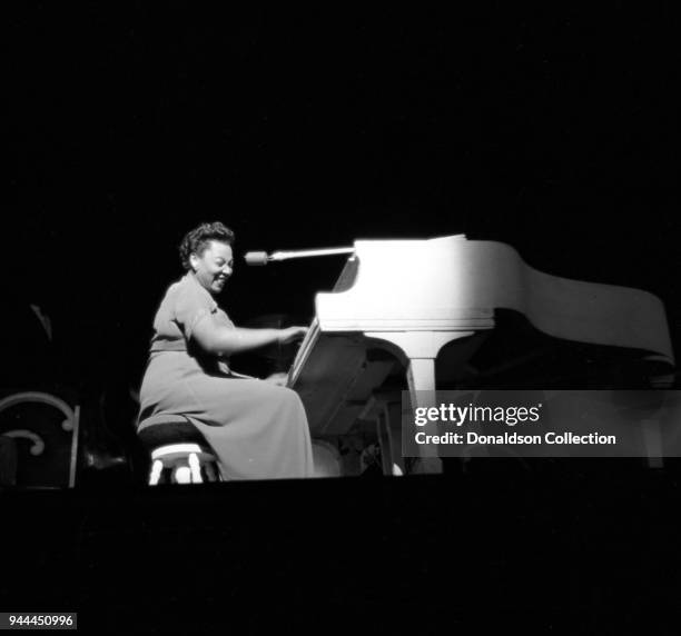 Entertainer Rose Murphy plays piano on stage with the Art Mooney Orchestra in April 1949 in New York.