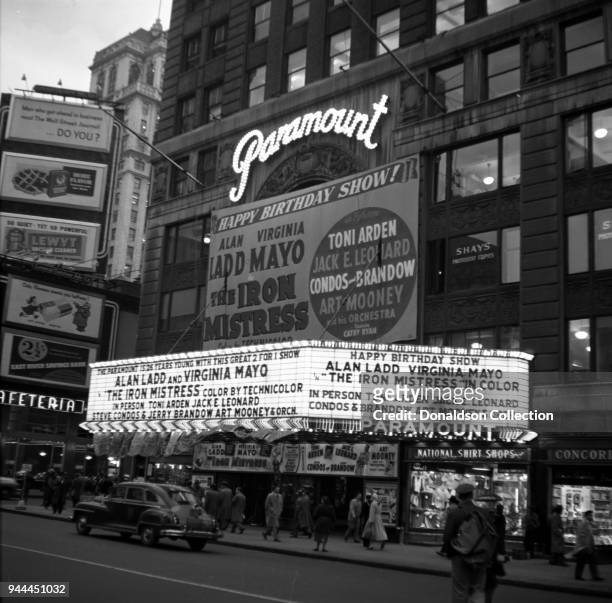 The Paramount Theatre marquee reads "The Paramount is 26 years young with this great 2 for 1 show; Alan Ladd and Virgnia Mayo 'The Iron Mistress'...