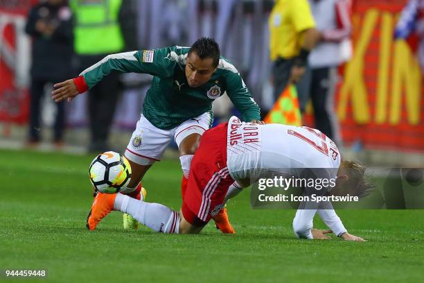 Guadalajara defender Edwin Hernandez battles New York Red Bulls midfielder Daniel Royer during the first half of the CONCACAF Champions League game...