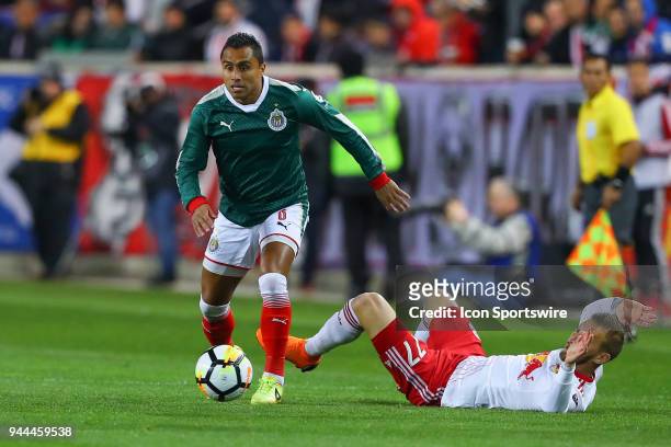 Guadalajara defender Edwin Hernandez battles New York Red Bulls midfielder Daniel Royer during the first half of the CONCACAF Champions League game...