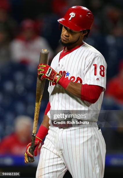 Pedro Florimon of the Philadelphia Phillies inspects his broken bat during a game against the Miami Marlins at Citizens Bank Park on April 7, 2018 in...