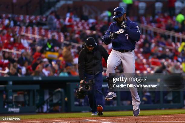 Eric Thames of the Milwaukee Brewers crosses home plate after hitting a home run against the St. Louis Cardinals in the first inning at Busch Stadium...