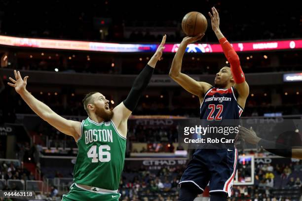 Otto Porter Jr. #22 of the Washington Wizards puts up a shot against Aron Baynes of the Boston Celtics in the first half at Capital One Arena on...