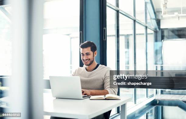 positivity predicts productivity - happy businessman working at his office with laptop stock pictures, royalty-free photos & images