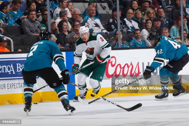 Charlie Coyle of the Minnesota Wild skates against Paul Martin and Joel Ward of the San Jose Sharks at SAP Center on April 7, 2018 in San Jose,...