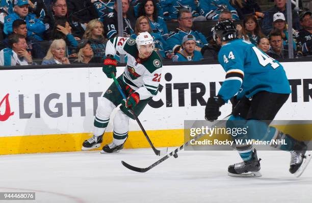 Nino Niederreiter of the Minnesota Wild skates against Marc-Edouard Vlasic of the San Jose Sharks at SAP Center on April 7, 2018 in San Jose,...