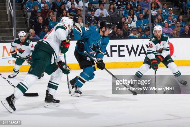 Timo Meier of the San Jose Sharks skates after the puck against Nino Niederreiter and Nate Prosser of the Minnesota Wild at SAP Center on April 7,...