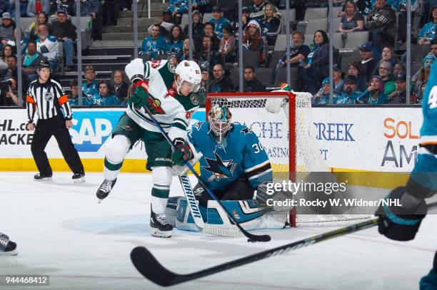 Aaron Dell of the San Jose Sharks defends the net against Tyler Ennis of the Minnesota Wild at SAP Center on April 7, 2018 in San Jose, California....