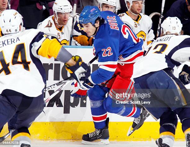 Brian Boyle of the New York Rangers skates against Tim Kennedy and Andrej Sekera of the Buffalo Sabres on December 12, 2009 at Madison Square Garden...