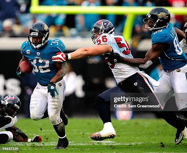 Brian Cushing of the Houston Texans attempts to tackle Maurice Jones-Drew of the Jacksonville Jaguars during the game at Jacksonville Municipal...