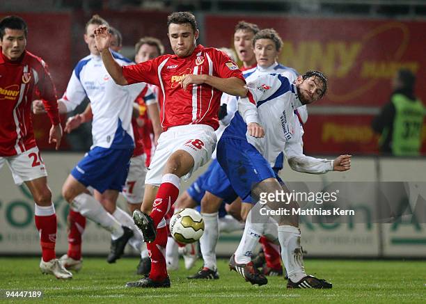 Kevin Schlitte of Rostock battles for the ball with John Adam Straith of Cottbus during the Second Bundesliga match between FC Energie Cottbus and FC...