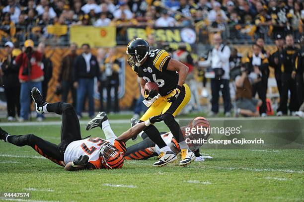 Wide receiver Hines Ward of the Pittsburgh Steelers runs with the football after catching a pass against linebacker Dhani Jones and safety Chinedum...
