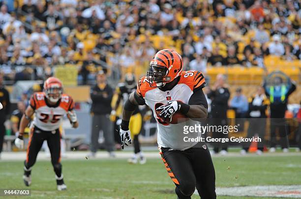 Defensive lineman Frostee Rucker of the Cincinnati Bengals runs with the football after intercepting a pass against the Pittsburgh Steelers at Heinz...