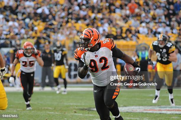 Defensive lineman Frostee Rucker of the Cincinnati Bengals runs with the football after intercepting a pass against the Pittsburgh Steelers at Heinz...