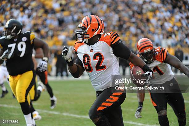 Defensive lineman Frostee Rucker of the Cincinnati Bengals runs with the football after intercepting a pass against the Pittsburgh Steelers at Heinz...