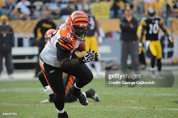 Defensive lineman Frostee Rucker of the Cincinnati Bengals runs with the football after intercepting a pass against the Pittsburgh Steelers at Heinz...