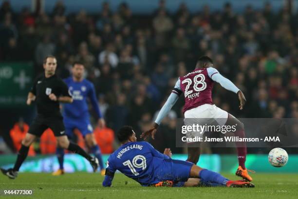 Axel Tuanzebe of Aston Villa is injured during this challenge from Nathaniel Mendez-Laing of Cardiff City during the Sky Bet Championship match...