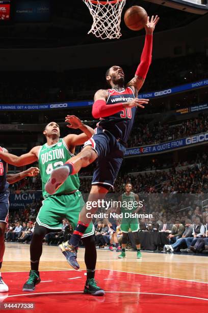 Mike Scott of the Washington Wizards goes to the basket against the Boston Celtics on April 10, 2018 at Capital One Arena in Washington, DC. NOTE TO...