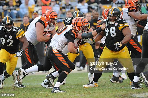 Offensive linemen Andrew Whitworth and Kyle Cook of the Cincinnati Bengals block against defensive linemen Brett Keisel and Casey Hampton of the...