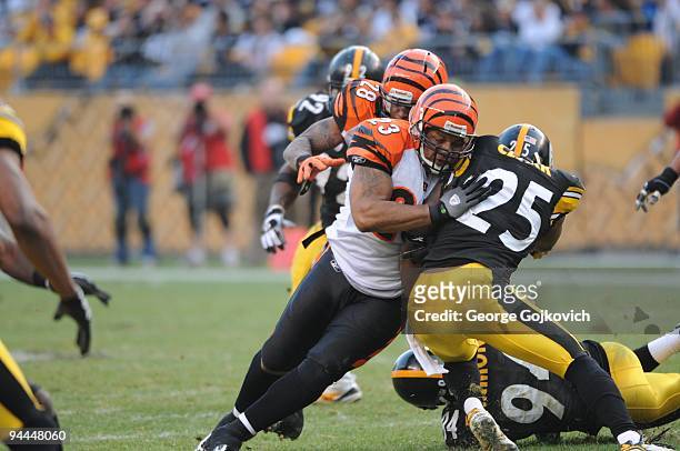 Fullback Jeremi Johnson of the Cincinnati Bengals blocks safety Ryan Clark of the Pittsburgh Steelers as Bernard Scott runs the football during a...