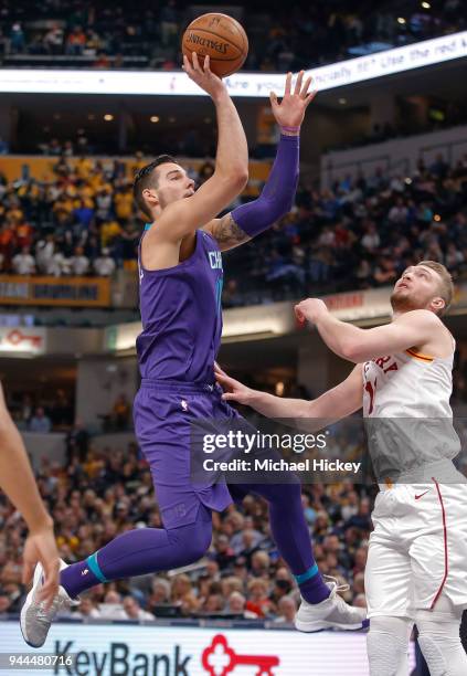 Willy Hernangomez of the Charlotte Hornets shoots the ball over Domantas Sabonis of the Indiana Pacers at Bankers Life Fieldhouse on March 15, 2018...