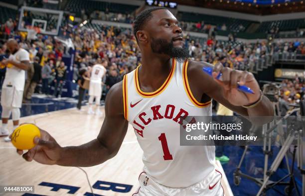 Lance Stephenson of the Indiana Pacers throws an autographed ball in the stands following the game against the Charlotte Hornets at Bankers Life...