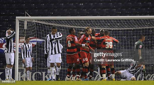 Queens Park Rangers players celebrate the own goal of Jonas Olsson of West Bromwich Albion during the Coca-Cola Championship match between West...