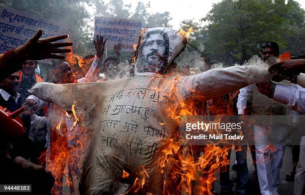 Activists of Shiv Sena burn the effigy of Afzal Guru and demand him to be hanged in a protest in New Delhi on Sunday, December 13, 2009.