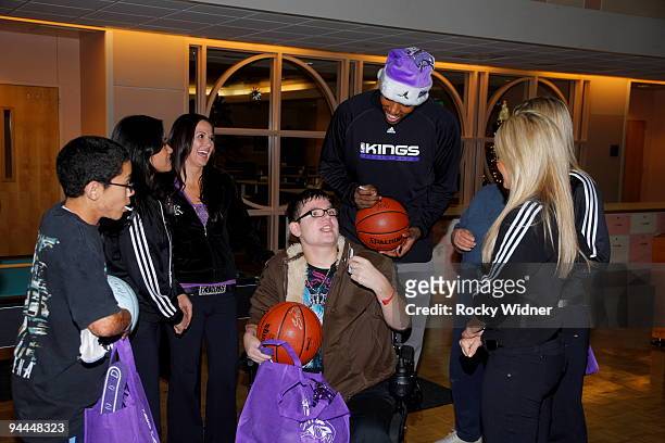 Jason Thompson of the Sacramento Kings along with members of the Sacramento Kings Dance Team got an ear full from a young fan on December 13, 2009 at...