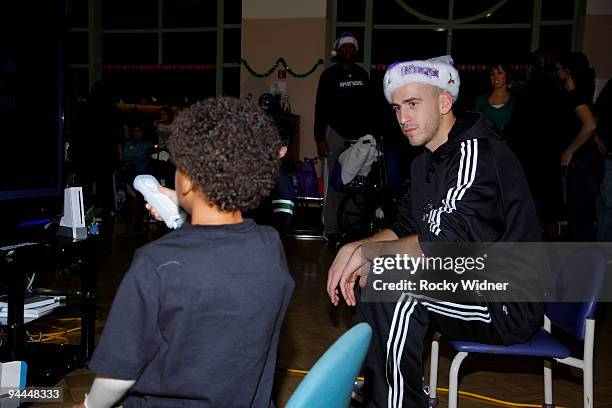 Sergio Rodriguez of the Sacramento Kings meets a new fan on December 13, 2009 at Shriners Hospital for Children in Sacramento, California. NOTE TO...