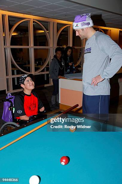 Jon Brockman of the Sacramento Kings talks with a young fan on December 13, 2009 at Shriners Hospital for Children in Sacramento, California. NOTE TO...