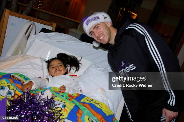 Sergio Rodriguez of the Sacramento Kings spends some time with a young fan on December 13, 2009 at Shriners Hospital for Children in Sacramento,...