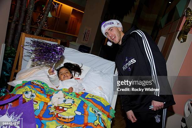 Sergio Rodriguez of the Sacramento Kings spends some time with a young fan on December 13, 2009 at Shriners Hospital for Children in Sacramento,...