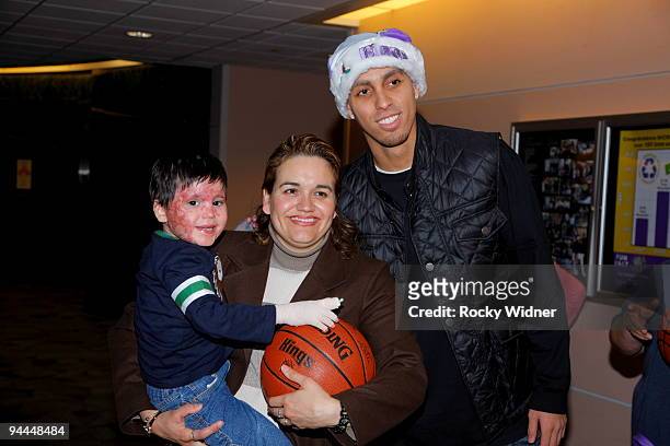 Kevin Martin of the Sacramento Kings poses for a photo with a family on December 13, 2009 at Shriners Hospital for Children in Sacramento,...