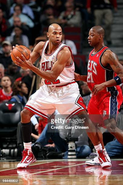 Taj Gibson of the Chicago Bulls posts up against Bobby Simmons of the New Jersey Nets during the game on December 8, 2009 at the United Center in...