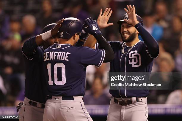 Hunter Renfroe of the San Diego Padres is congratulated at the plate by Manuel Margot and Eric Hosmer after hitting a 3 RBI home run in the seventh...